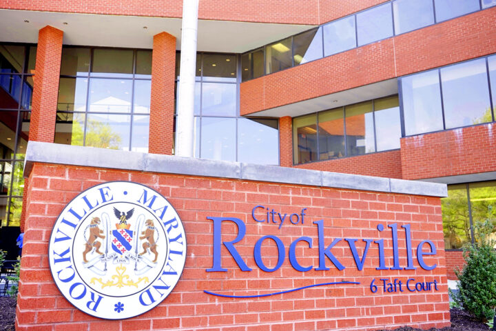 Exterior view of the City of Rockville, Maryland municipal building with a large sign displaying the city name and emblem in front.