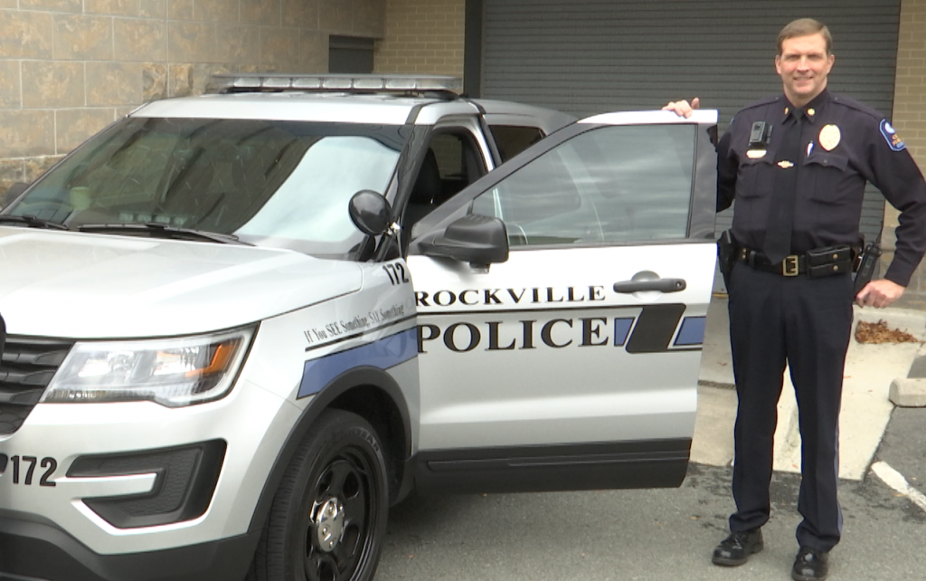 Maj. Robert J. Rappoport photo with police vehicle in 2018.