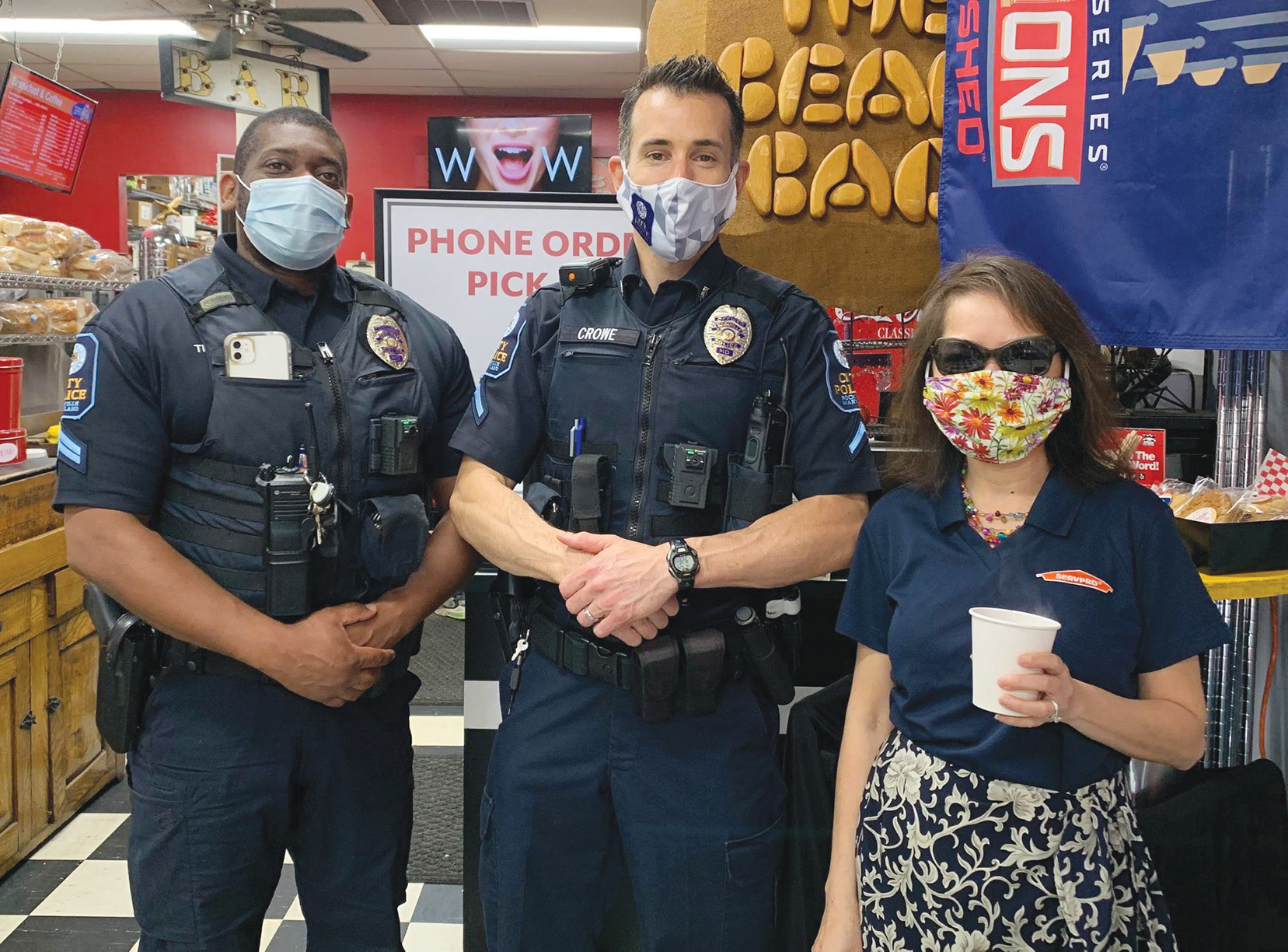 2 officers and patron at coffee shop