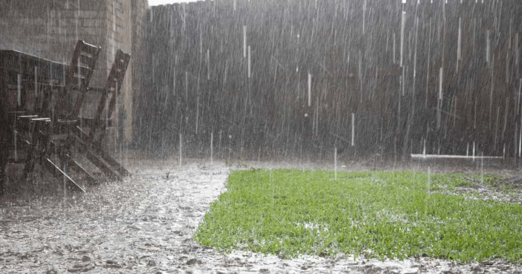 A backyard during a rainstorm being flooded
