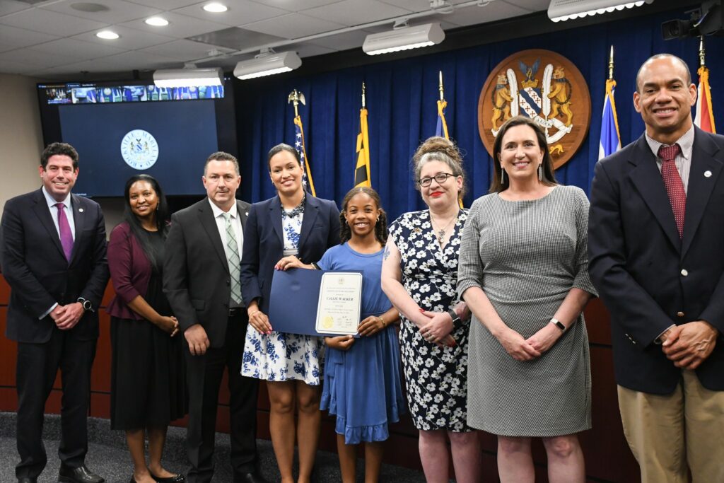 Callie Walker receives her award from the Rockville Mayor and Council