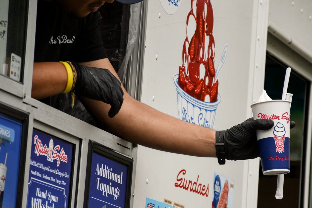 Person handing off an ice cream 