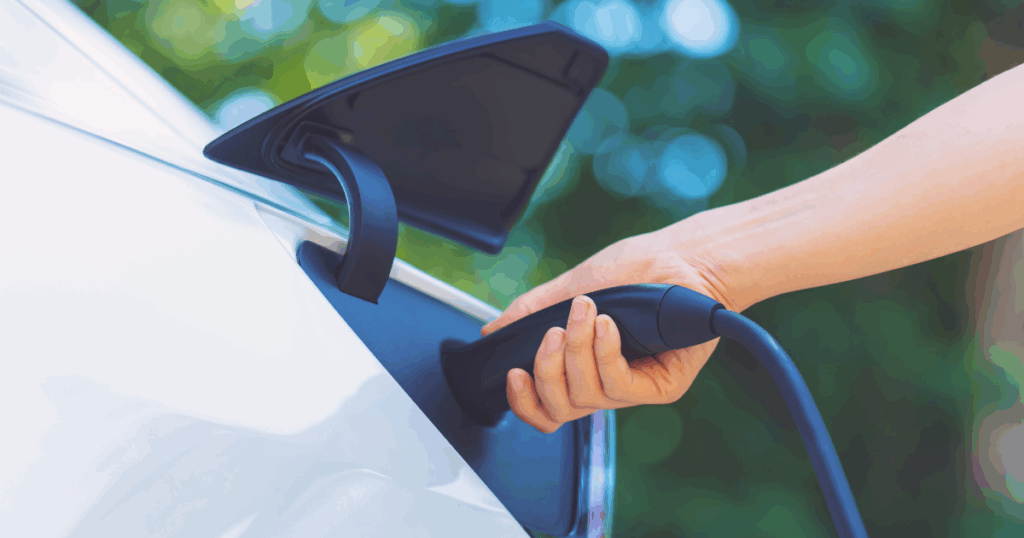 Person charging their electric vehicle