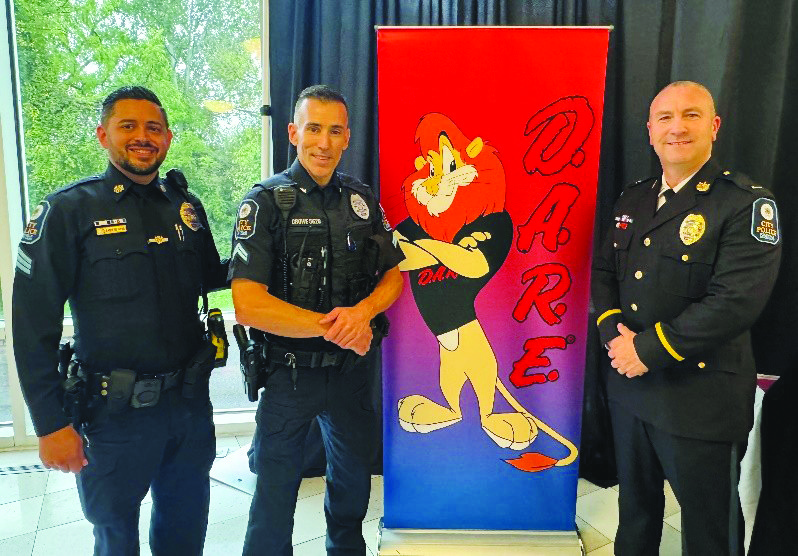 Rockville police officers in front of a DARE sign
