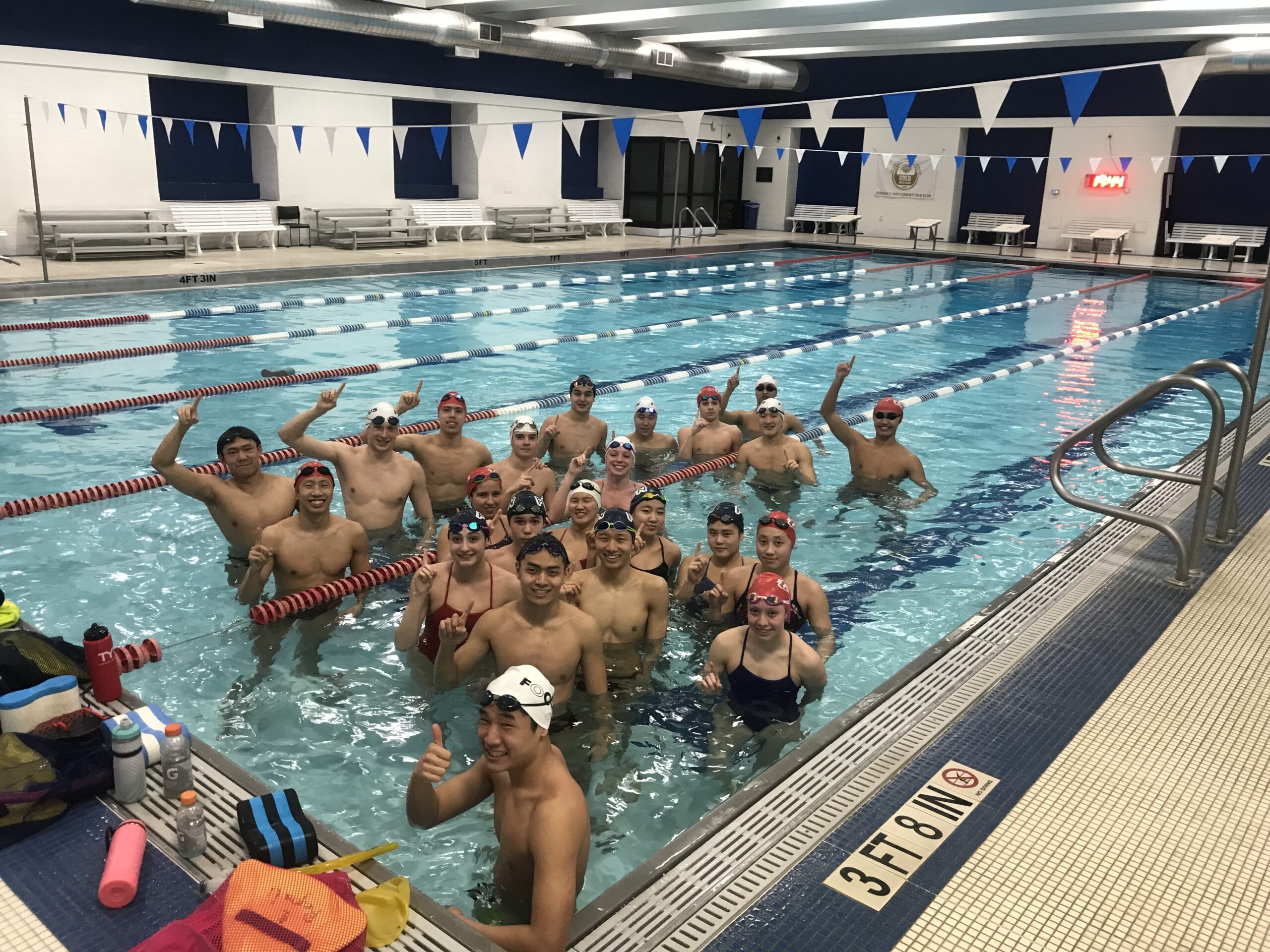 Rockville-Montgomery Swim Club posing for a picture in a pool