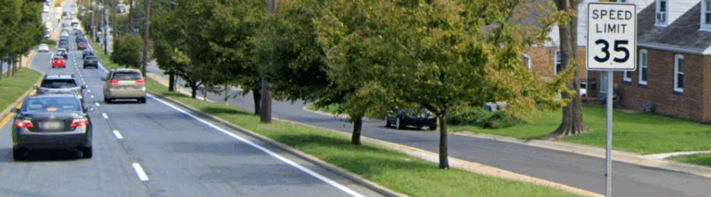 Image depicts traffic on Veirs Mill with a 35 mile per hour speed limit sign on the right.