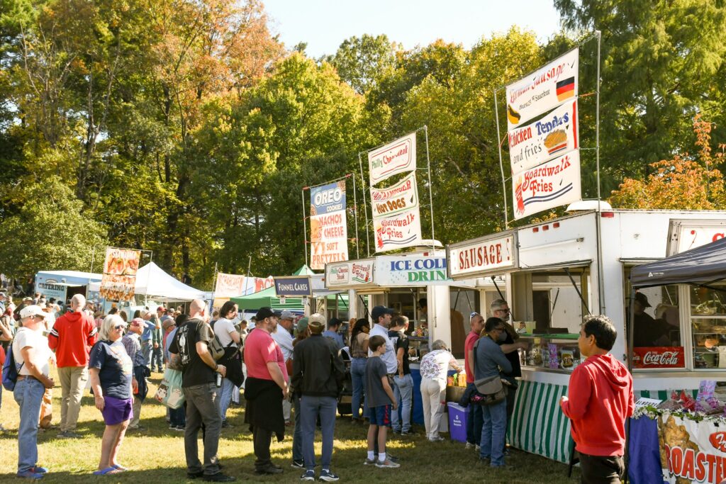 People in line at food vendors at Rockville Antique and Classic Car Show