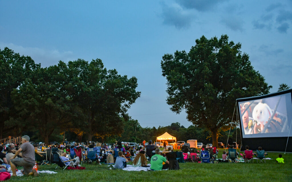 A group of people sitting in a park.