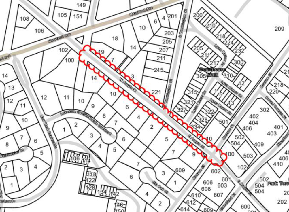 A black and white map highlights a long, narrow stretch of properties with a red outline and dots running down the center, intersecting multiple property lots.