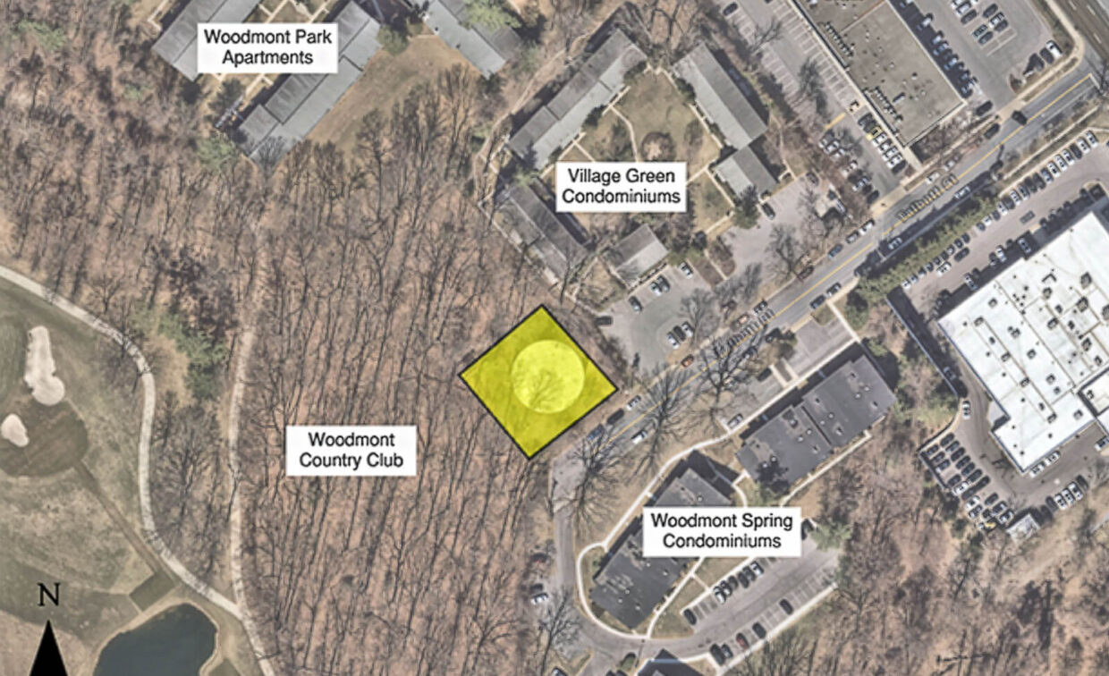Aerial view showing a highlighted lot among labeled buildings: Woodmont Park Apartments, Village Green Condominiums, Woodmont Spring Condominiums, and Woodmont Country Club.