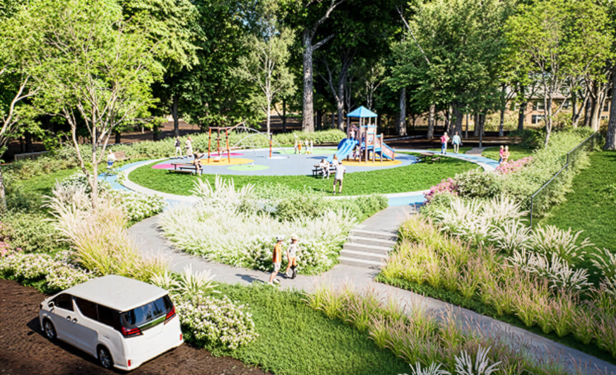 A playground with slides and swings is surrounded by greenery and walking paths; children and adults are present, and a white car is parked nearby.