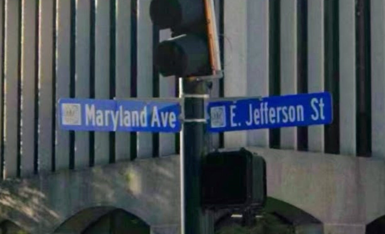 Street signs at an intersection display 
