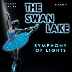 Ballerina in a glowing blue tutu poses en pointe against a black background. Text reads: “The Swan Lake Symphony of Lights.” Logos appear in the corners.