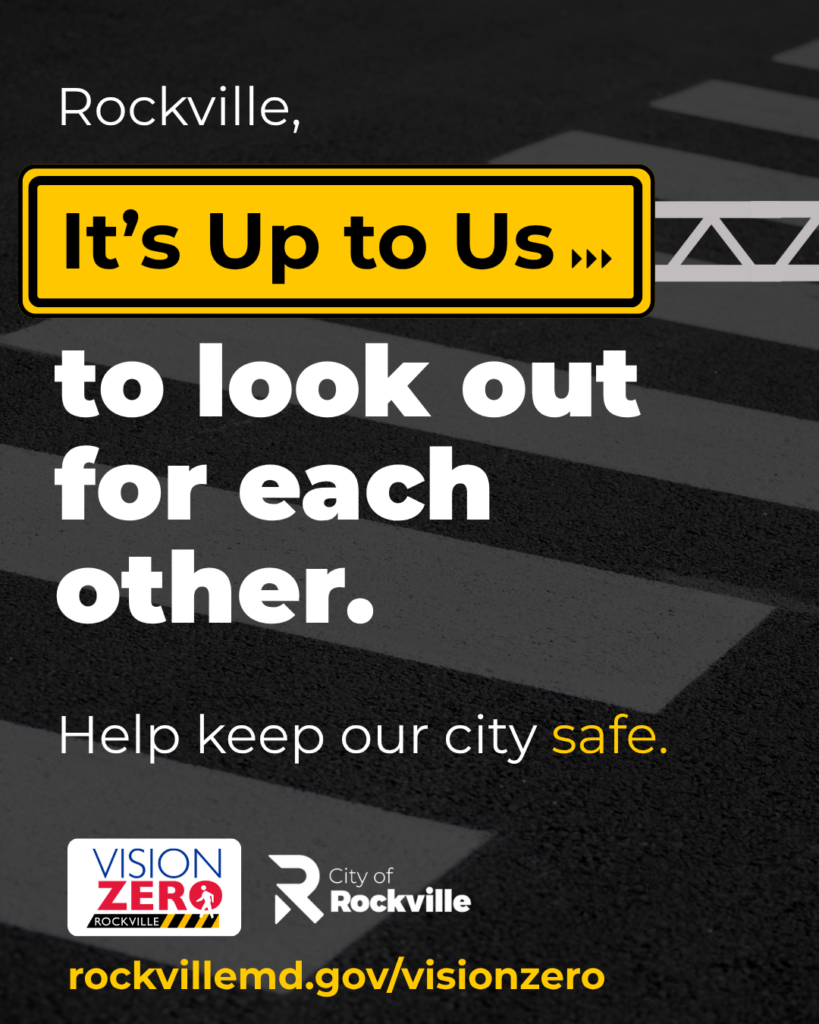 A crosswalk with a safety message reading “It’s Up to Us to look out for each other,” urging pedestrian safety in Rockville.